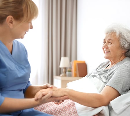 nurse holding elderly senior patients hand