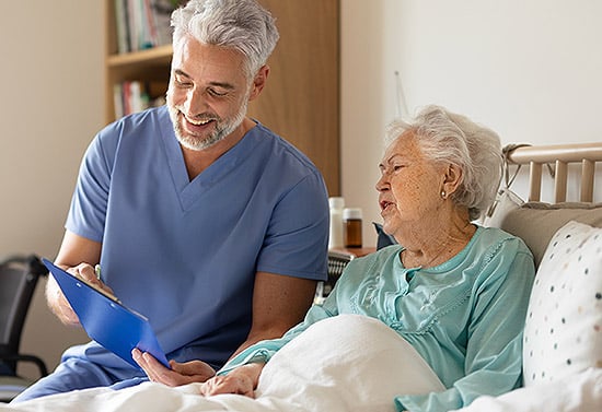 nurse with patient looking at clipboard