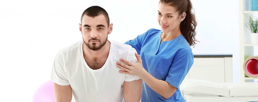 nurse assisting patient in stretches