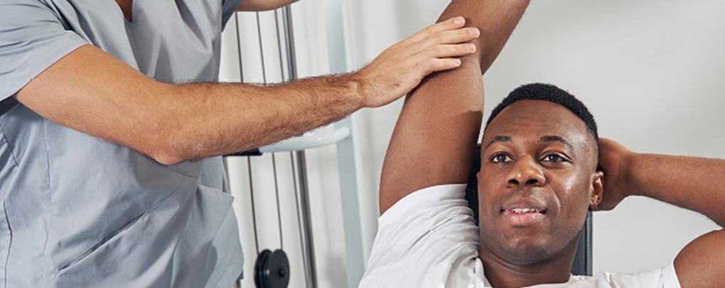 therapist helping patient stretch