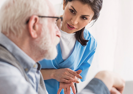 Speech therapist talking to senior patient