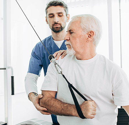 Senior patient training with his occupational therapist recovery with special exercises