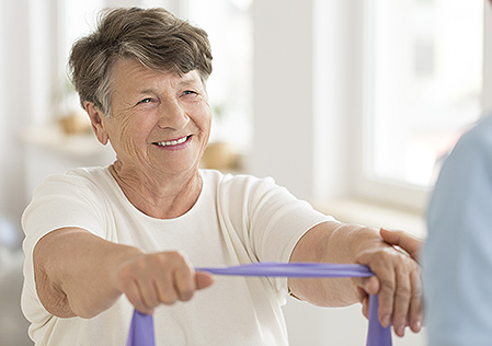 Senior woman with elastic tape