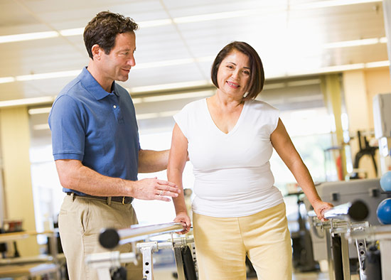 Physical therapist and patient walking