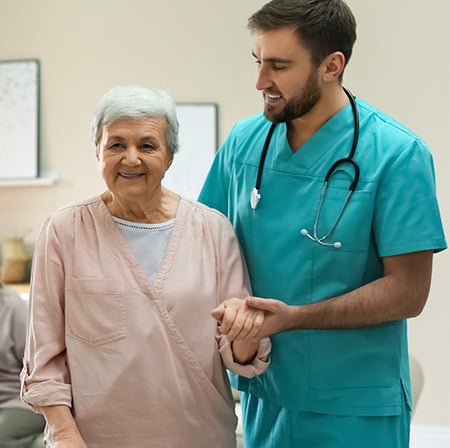 nurse assiting senior patient walking