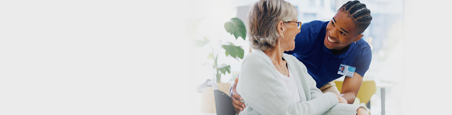 Nurse assisting senior patient on wheelchair