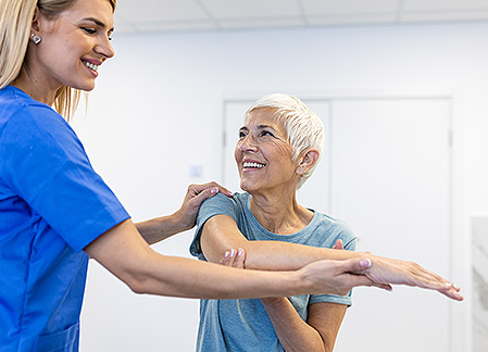 physical therapist assisting patient in a stretch