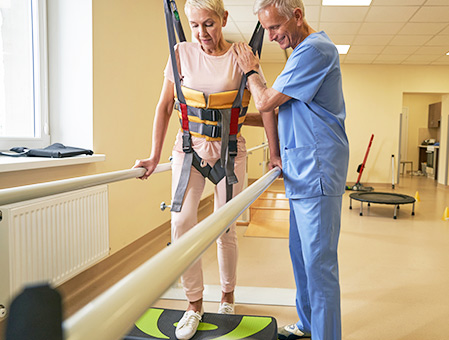 therapist assisting patient undergoing physical therapy