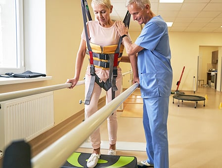 therapist assisting patient undergoing physical therapy