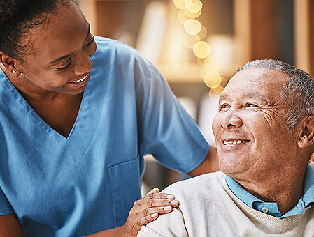 closeup of a nurse and patient smiling 