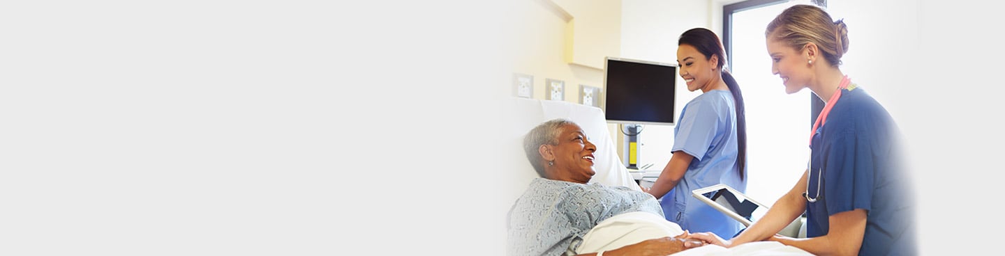 nurses monitoring patient in bed