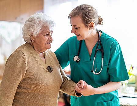 nurse assisting elderly patient