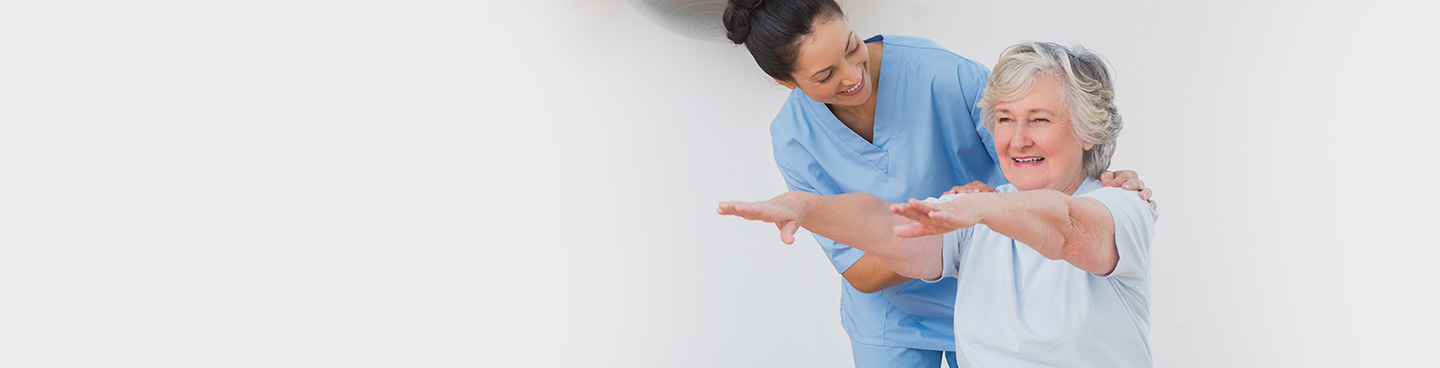 therapist assisting patient with stretches