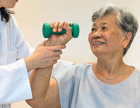elderly woman lifting light weights