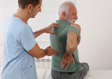 Spine physical therapist and patient