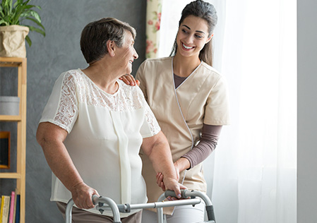 Patient with walker assisted by nurse